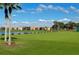 Well-maintained golf driving range overlooking a lake with seating and lush green grass at 8105 Grand Estuary Trl # 105, Bradenton, FL 34212