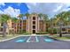 Beautiful condominium building featuring well-maintained landscaping with lush, mature palm trees at 8105 Grand Estuary Trl # 105, Bradenton, FL 34212