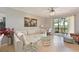 Beautifully staged living room offering a cozy seating arrangement and access to a private lanai at 8105 Grand Estuary Trl # 105, Bradenton, FL 34212