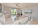 This living room features a sliding glass door to the outside and views of a golf course at 8105 Grand Estuary Trl # 105, Bradenton, FL 34212