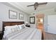 Comfortable primary bedroom with ceiling fan and an ensuite bathroom with a tiled shower at 8105 Grand Estuary Trl # 105, Bradenton, FL 34212