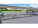 Covered parking lot area with clearly marked spaces and well-maintained landscaping at 8105 Grand Estuary Trl # 105, Bradenton, FL 34212