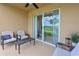 Cozy screened-in patio featuring comfortable seating, a table, and views of the golf course at 8105 Grand Estuary Trl # 105, Bradenton, FL 34212