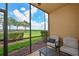 Relaxing screened patio with comfortable seating and views of the lush green landscape and blue sky at 8105 Grand Estuary Trl # 105, Bradenton, FL 34212