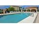 Community pool with clear blue water, lounge chairs, and covered seating area at 8105 Grand Estuary Trl # 105, Bradenton, FL 34212