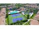 Aerial view featuring tennis courts, community pool, clubhouse and meticulously manicured landscaping at 8315 Glenrose Way # 1421, Sarasota, FL 34238