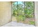 Screened balcony featuring tile flooring and tranquil views of lush greenery and mature trees at 8315 Glenrose Way # 1421, Sarasota, FL 34238