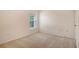 Well-lit bedroom with a window and neutral carpet at 8315 Glenrose Way # 1421, Sarasota, FL 34238