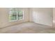 Bedroom featuring plush carpeting, neutral walls and a window offering natural light at 8315 Glenrose Way # 1421, Sarasota, FL 34238
