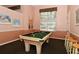 Charming billiards room featuring a pool table and seating with ample natural light at Pinetone community at 8315 Glenrose Way # 1421, Sarasota, FL 34238