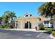 Exterior shot of the Pinetone community clubhouse featuring elegant architecture and beautiful landscaping at 8315 Glenrose Way # 1421, Sarasota, FL 34238