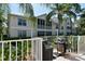 Outdoor grilling area features gas grills, a white fence, landscaping and nearby palm trees at 8315 Glenrose Way # 1421, Sarasota, FL 34238
