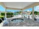 Community hot tub under a covered area surrounded by a white fence and tropical landscaping at 8315 Glenrose Way # 1421, Sarasota, FL 34238