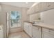 Kitchen showcasing a double sink, tiled floor, and white appliances at 8315 Glenrose Way # 1421, Sarasota, FL 34238