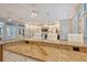Lounge with kitchenette, featuring a granite bar top with comfortable chairs and billiard area nearby at 8315 Glenrose Way # 1421, Sarasota, FL 34238