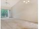 Bright living room with vaulted ceiling, ceiling fan, and sliding glass doors leading to a balcony with lush views at 8315 Glenrose Way # 1421, Sarasota, FL 34238