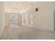 Spacious living room with neutral carpet and access to the kitchen and other rooms at 8315 Glenrose Way # 1421, Sarasota, FL 34238