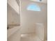 Light-filled loft featuring vaulted ceilings, a unique arched window, and a staircase with white railings at 8315 Glenrose Way # 1421, Sarasota, FL 34238