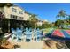 A circle of blue adirondack chairs provides a relaxing outdoor setting in the community at 8315 Glenrose Way # 1421, Sarasota, FL 34238