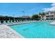 A stunning community pool awaits with many lounge chairs available under a bright blue sky at 8315 Glenrose Way # 1421, Sarasota, FL 34238