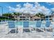 A refreshing community pool is surrounded by many chairs and lovely landscaping at 8315 Glenrose Way # 1421, Sarasota, FL 34238