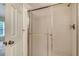 Bathroom featuring a glass-enclosed shower with white tiled walls at 8315 Glenrose Way # 1421, Sarasota, FL 34238