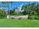 Elegant Pinetone at Palmer Ranch community sign surrounded by manicured lawn and lush greenery at 8315 Glenrose Way # 1421, Sarasota, FL 34238