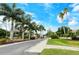 Scenic street lined with palm trees and lush landscaping at the beautiful Pinetone community entrance at 8315 Glenrose Way # 1421, Sarasota, FL 34238