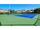 Community tennis courts, surrounded by tropical plants, is ready for a match at 8315 Glenrose Way # 1421, Sarasota, FL 34238