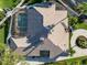 An aerial view of the home showcasing its screened-in pool, lanai, and well-maintained roof at 8321 9Th Avenue Nw Ter, Bradenton, FL 34209