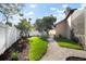 Landscaped backyard featuring lush green lawn, gravel pathways, and tropical plants at 8321 9Th Avenue Nw Ter, Bradenton, FL 34209
