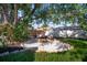 Backyard with firepit, outdoor seating, lush lawn, and mature shade tree at 8321 9Th Avenue Nw Ter, Bradenton, FL 34209