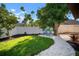 Backyard featuring lush green lawn, rock landscaping, and shade trees at 8321 9Th Avenue Nw Ter, Bradenton, FL 34209