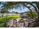 Backyard with stone firepit area, lush lawn, and mature trees at 8321 9Th Avenue Nw Ter, Bradenton, FL 34209