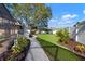 Large, landscaped backyard with gravel pathway and screened-in lanai at 8321 9Th Avenue Nw Ter, Bradenton, FL 34209