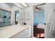Bright bathroom with large vanity; doorway leads to bedroom with blue walls at 8321 9Th Avenue Nw Ter, Bradenton, FL 34209