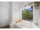 Bright bathroom showcasing a large soaking tub with a view of lush greenery at 8321 9Th Avenue Nw Ter, Bradenton, FL 34209