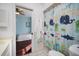 This bright bathroom with a shower features a doorway that leads to the bedroom at 8321 9Th Avenue Nw Ter, Bradenton, FL 34209