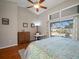 Bright bedroom featuring hardwood floors, vaulted ceilings, and a sliding glass door leading to the screened-in pool area at 8321 9Th Avenue Nw Ter, Bradenton, FL 34209