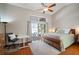 Comfortable bedroom with hardwood floors, vaulted ceilings, and sliding glass door overlooking the pool at 8321 9Th Avenue Nw Ter, Bradenton, FL 34209