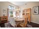 Inviting dining room with wooden table, hutch and ample natural light from the large window at 8321 9Th Avenue Nw Ter, Bradenton, FL 34209