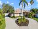 Beautiful home featuring a circular driveway, manicured landscaping, and a welcoming facade on a sunny day at 8321 9Th Avenue Nw Ter, Bradenton, FL 34209