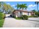 Well-maintained exterior with tropical landscaping, palm trees, and arched windows at 8321 9Th Avenue Nw Ter, Bradenton, FL 34209
