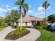 Beautiful single Gathering home with a circular driveway, mature landscaping, and two palm trees at 8321 9Th Avenue Nw Ter, Bradenton, FL 34209