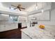 Bright kitchen featuring white cabinets, stainless steel appliances, granite countertops, and a skylight at 8321 9Th Avenue Nw Ter, Bradenton, FL 34209