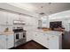 Modern kitchen with stainless steel appliances, granite countertops, white cabinets, and hardwood floors at 8321 9Th Avenue Nw Ter, Bradenton, FL 34209