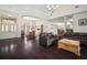 Open-concept living room with dark wood floors connecting to the dining and kitchen areas for easy entertaining at 8321 9Th Avenue Nw Ter, Bradenton, FL 34209