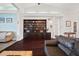 Cozy living room featuring a custom built-in bookshelf, dark wood floors, and plenty of natural light at 8321 9Th Avenue Nw Ter, Bradenton, FL 34209