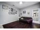 Cozy living room featuring dark hardwood floors, a comfortable leather sofa, and decorative wall art at 8321 9Th Avenue Nw Ter, Bradenton, FL 34209