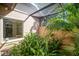 View of lush green landscaping outside sliding glass doors under a screened patio at 8321 9Th Avenue Nw Ter, Bradenton, FL 34209